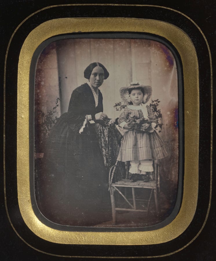 Child Standing on a Chair Holding Flowers, with Mother — artwork